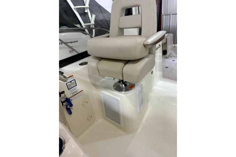 Slide: The Image of Captain's chair on 2022 Boston Whaler 325 Conquest boat, featuring beige upholstery and modern design. - 39