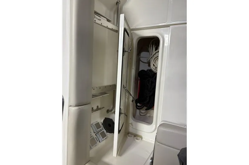 Slide: The Image of Interior storage compartment of 2022 Boston Whaler 325 Conquest boat with ropes and equipment. - 44