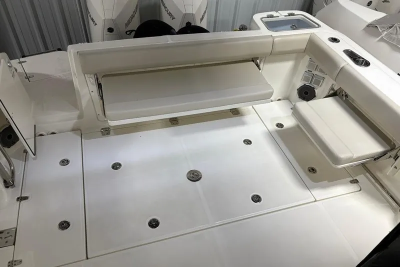 Slide: The Image of 2022 Boston Whaler 325 Conquest boat deck with seating and storage compartments. - 45