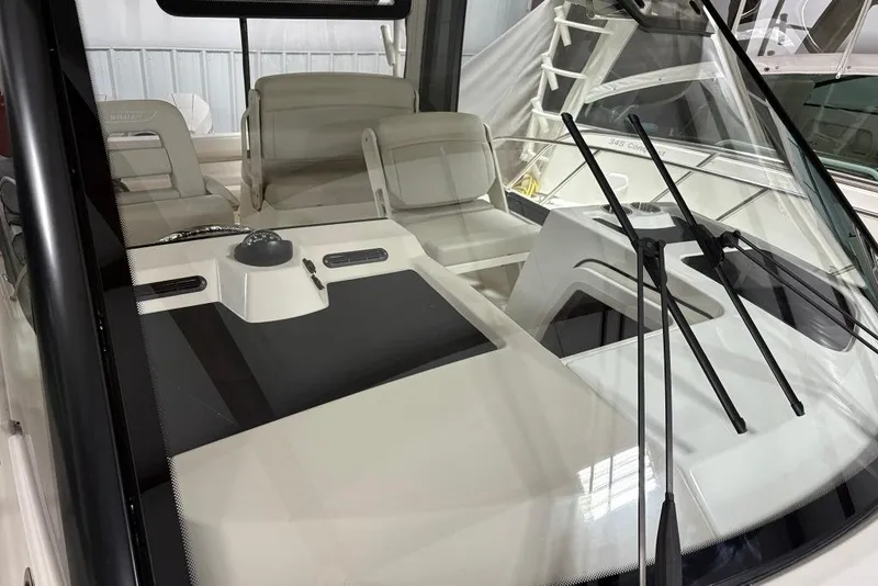 Slide: The Image of 2022 Boston Whaler 325 Conquest interior with windshield and seating area. - 49