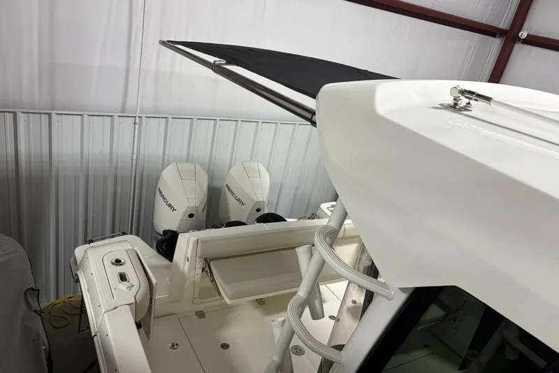Slide: The Image of 2022 Boston Whaler 325 Conquest boat with dual Mercury engines in storage. - 50