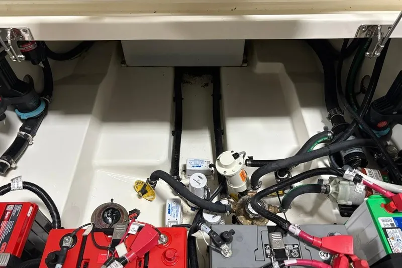 Slide: The Image of Engine compartment of a 2022 Boston Whaler 325 Conquest, showcasing batteries and wiring. - 9