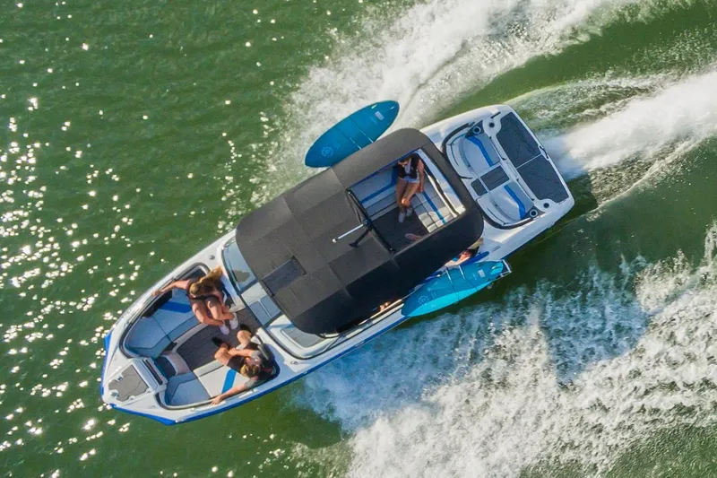 Slide: The Image of 2019 Yamaha Boats 242X E-Series interior with white and blue seating, speakers, and deck. - 6