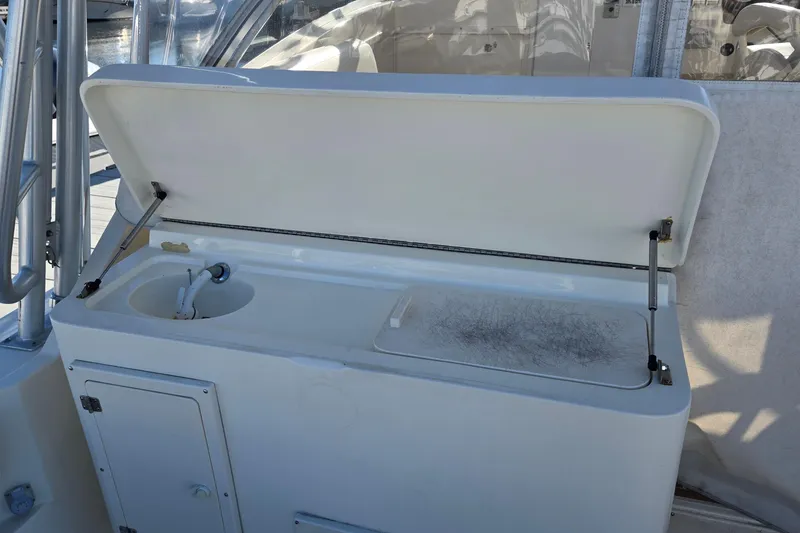 Slide: The Image of 2003 Albemarle 320 Express Fisherman boat sink and cutting board station. - 12