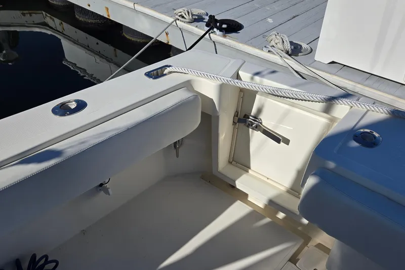 Slide: The Image of 2003 Albemarle 320 Express Fisherman boat interior with docked ropes and seating. - 14