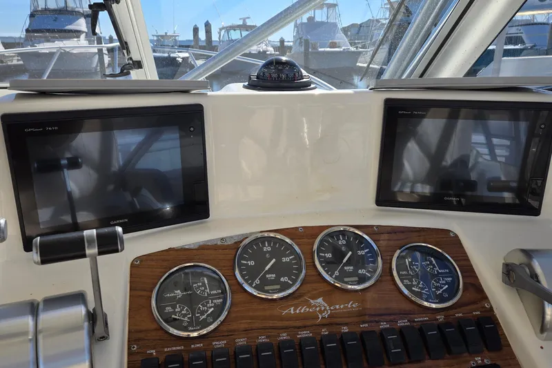 Slide: The Image of 2003 Albemarle 320 Express Fisherman dashboard with Garmin displays and gauges. - 20