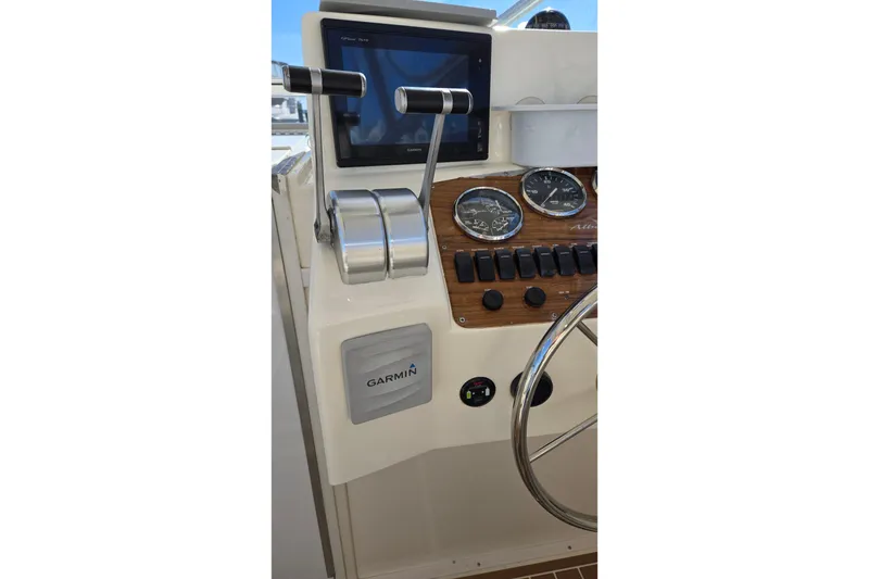 Slide: The Image of 2003 Albemarle 320 Express Fisherman helm with Garmin navigation and control panel. - 21