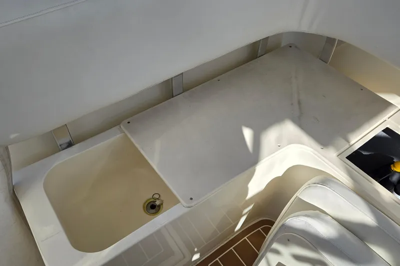 Slide: The Image of 2003 Albemarle 320 Express Fisherman interior with storage compartment and seating area. - 24