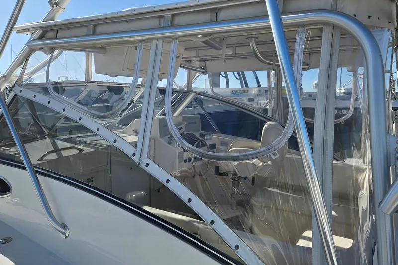 Slide: The Image of 2003 Albemarle 320 Express Fisherman boat with enclosed cockpit and steering wheel. - 25