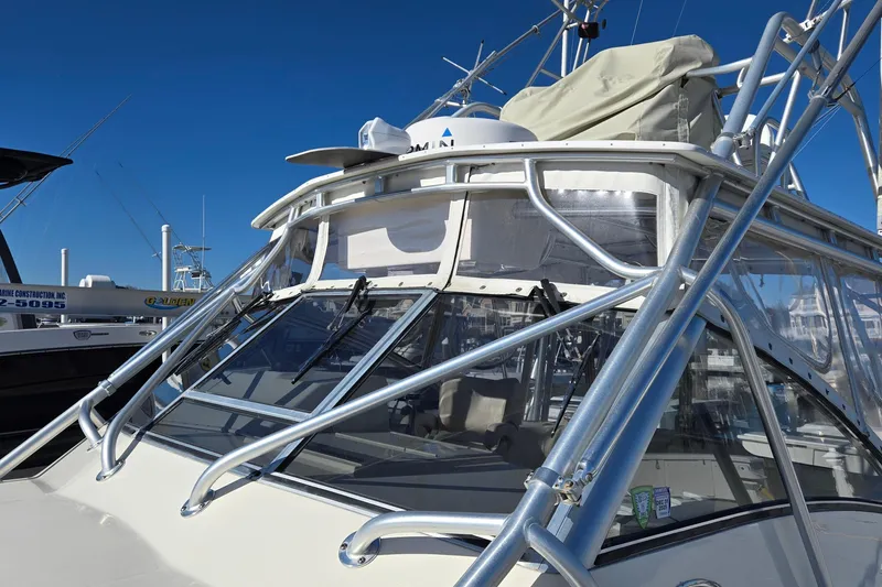 Slide: The Image of 2003 Albemarle 320 Express Fisherman boat with sleek metal framework and clear windows. - 27