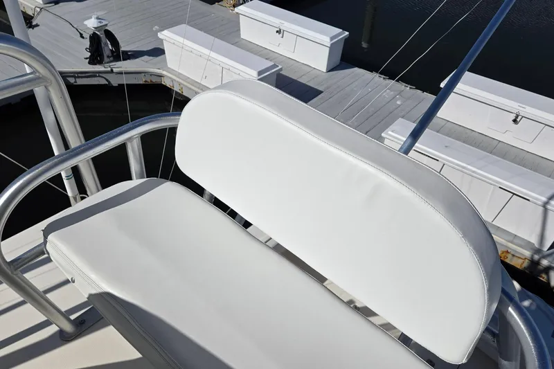 Slide: The Image of White cushioned seat on 2003 Albemarle 320 Express Fisherman boat, dockside view. - 29