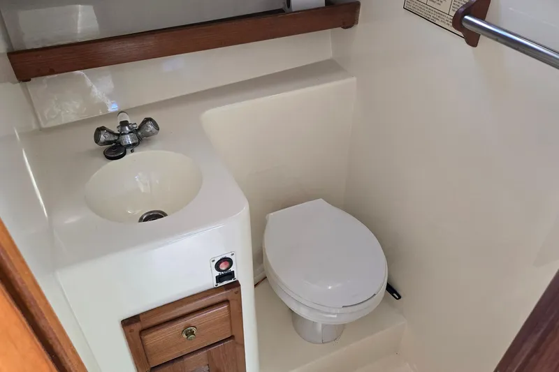 Slide: The Image of Compact bathroom in 2003 Albemarle 320 Express Fisherman boat with sink and toilet. - 3