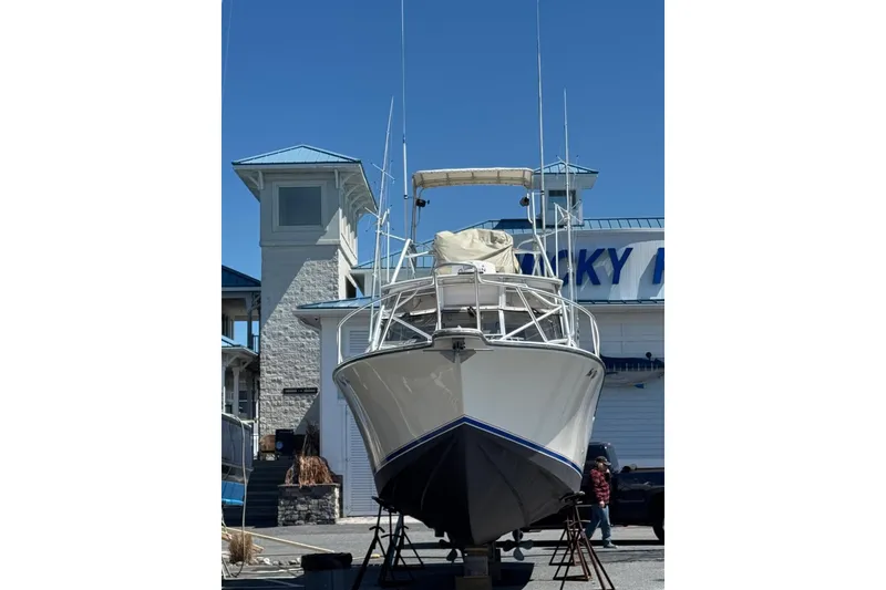 Slide: The Image of 2003 Albemarle 320 Express Fisherman boat on dry dock, with blue sky background. - 35