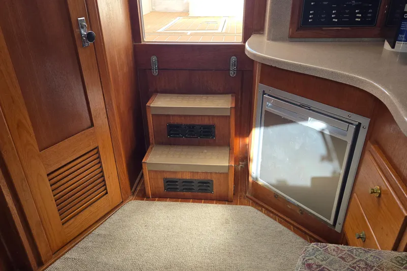 Slide: The Image of Interior of 2003 Albemarle 320 Express Fisherman with wooden steps and compact fridge. - 4
