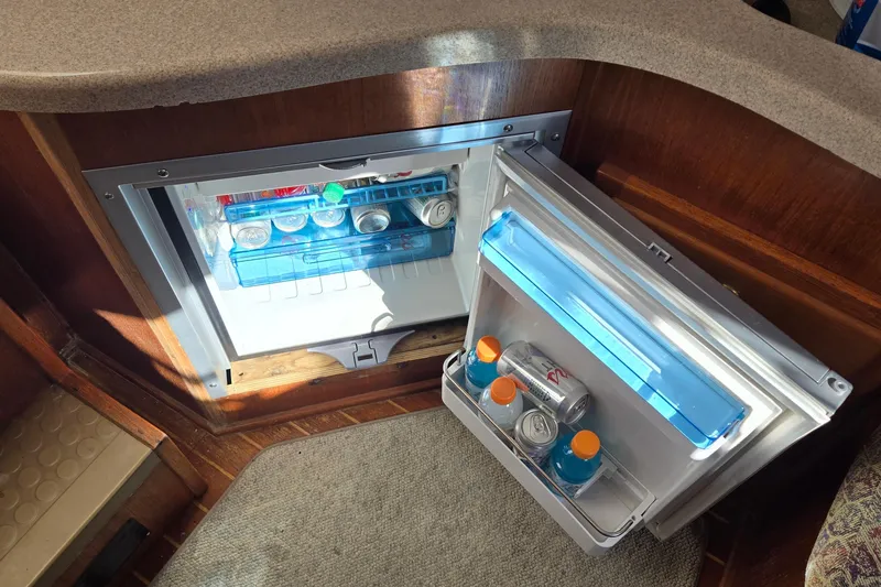 Slide: The Image of Open mini fridge on 2003 Albemarle 320 Express Fisherman, stocked with drinks. - 6