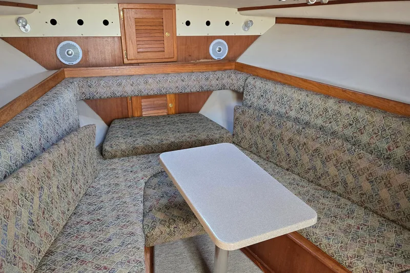 Slide: The Image of 2003 Albemarle 320 Express Fisherman cabin with patterned seating and wooden accents. - 7