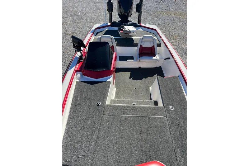 Slide: The Image of 2006 Bullet 21XD boat interior with red and white seating, gray carpet, and console. - 12