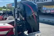 Slide: The Image of 2006 Bullet 21XD boat dashboard with steering wheel and navigation display. - 2