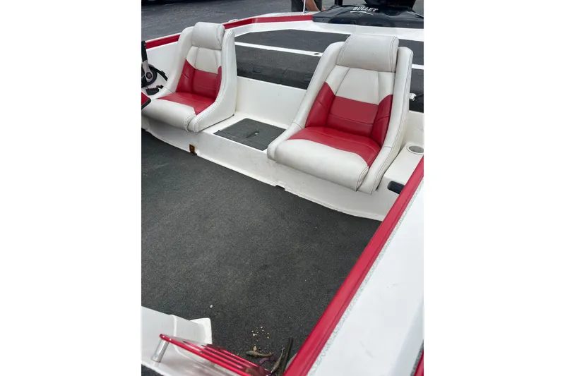 Slide: The Image of Interior view of a 2006 Bullet 21XD boat with red accents and speakers. - 9