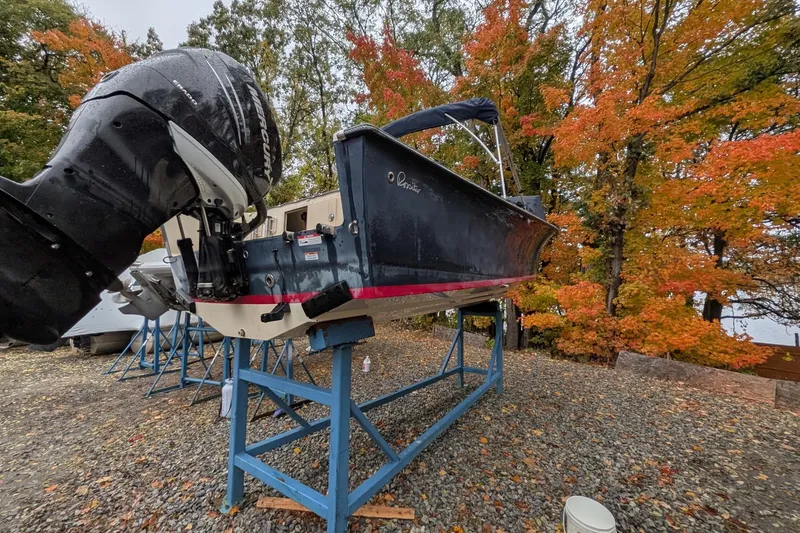 Slide: The Image of 2017 Rossiter R23 boat on stand, autumn trees in background. - 2