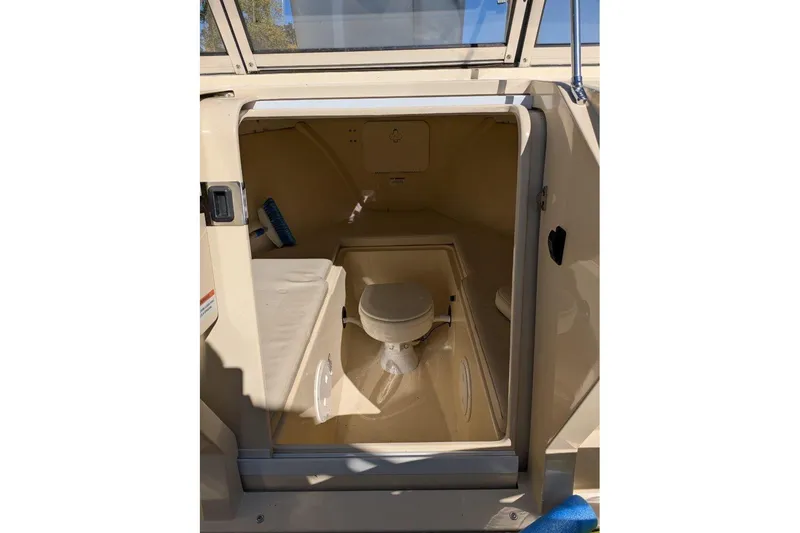 Slide: The Image of 2017 Rossiter R23 boat interior cabin with toilet and seating area. - 9