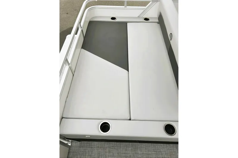 Slide: The Image of 2026 Sun Tracker Party Barge 22 RF DLX seating area with cup holders and cushioned seats. - 9