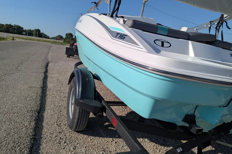 Slide: The Image of 2026 Tahoe T16 boat on trailer, parked on a sunny road. - 60
