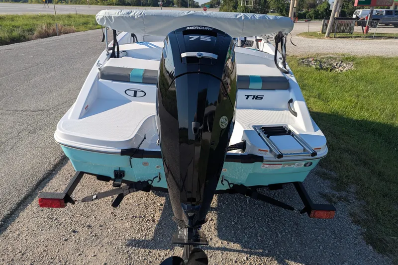 Slide: The Image of 2026 Tahoe T16 boat with Mercury 75 engine on a trailer, parked roadside. - 61