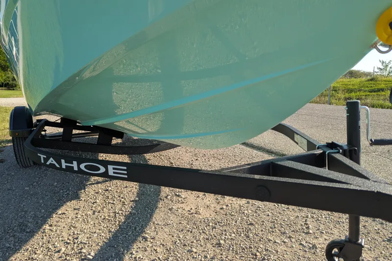 Slide: The Image of 2026 Tahoe T16 boat on trailer, parked on gravel road. - 66