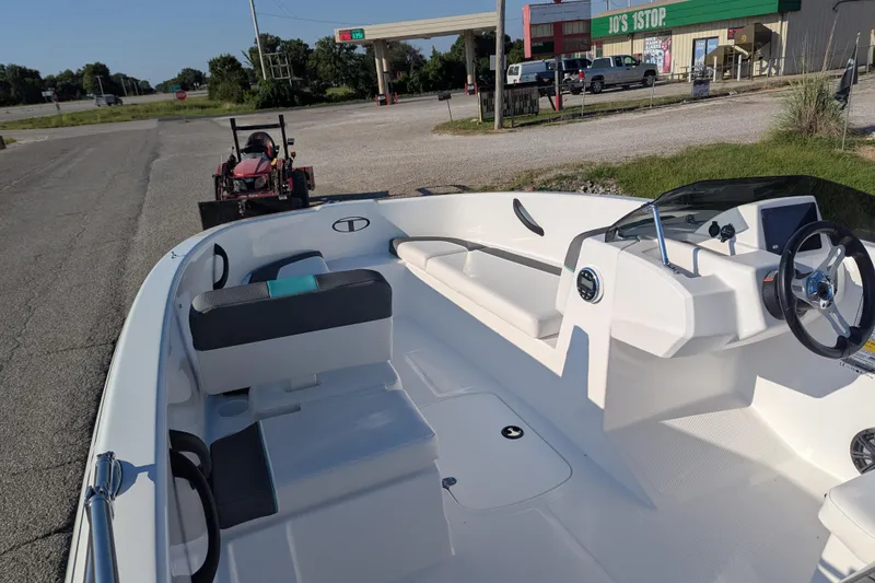 Slide: The Image of 2026 Tahoe T16 boat interior at a roadside stop with a gas station in the background. - 72