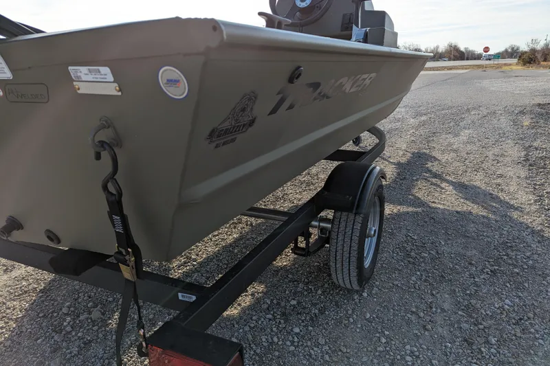 Slide: The Image of 2026 Tracker Grizzly 1648 SC boat on trailer, parked on gravel road. - 31