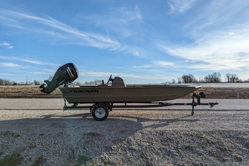 Slide: The Image of 2026 Tracker Grizzly 1648 SC boat on trailer under clear blue sky. - 33