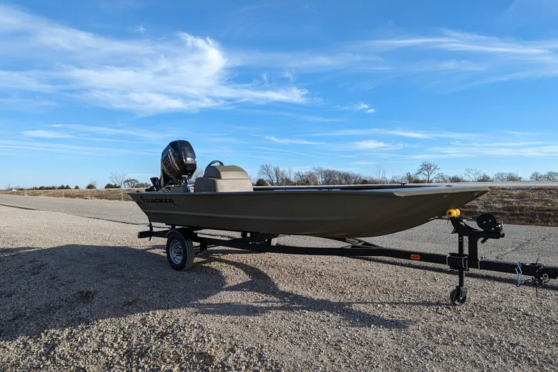 Slide: The Image of 2026 Tracker Grizzly 1648 SC boat on trailer under clear blue sky. - 34