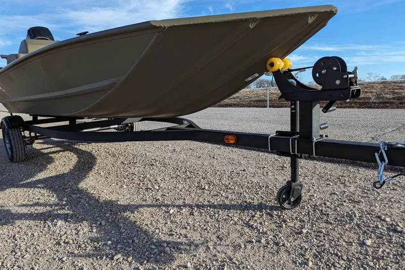 Slide: The Image of 2026 Tracker Grizzly 1648 SC boat on trailer, parked on gravel road. - 35
