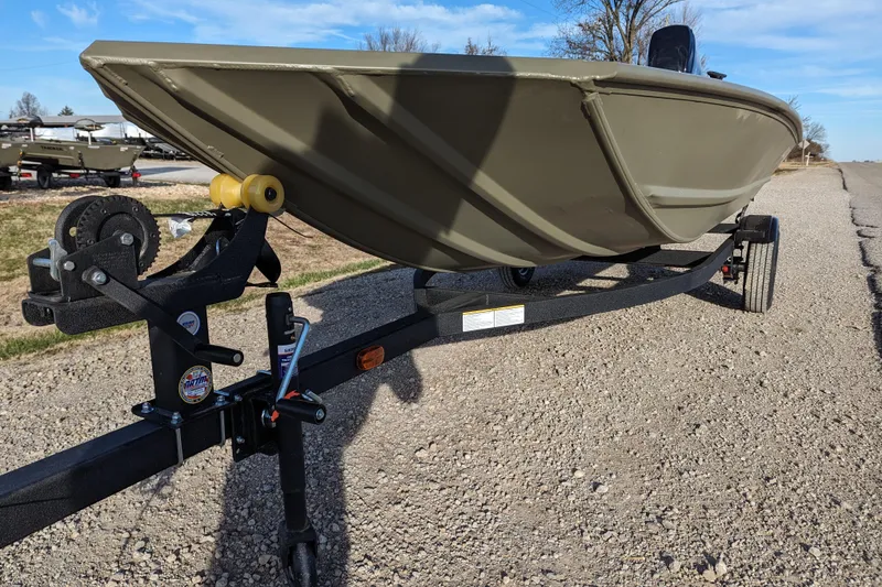 Slide: The Image of 2026 Tracker Grizzly 1648 SC boat on trailer, parked on gravel road. - 36