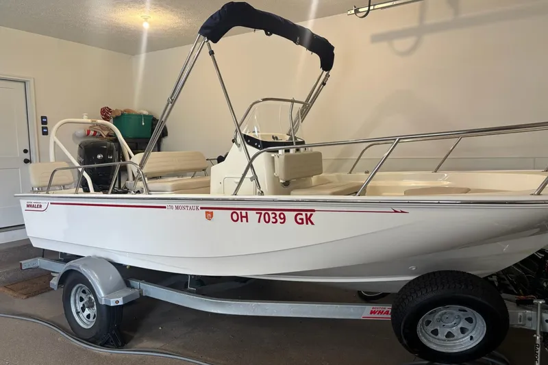 The Image of 2023 Boston Whaler 170 Montauk boat on trailer in garage setting. - 0