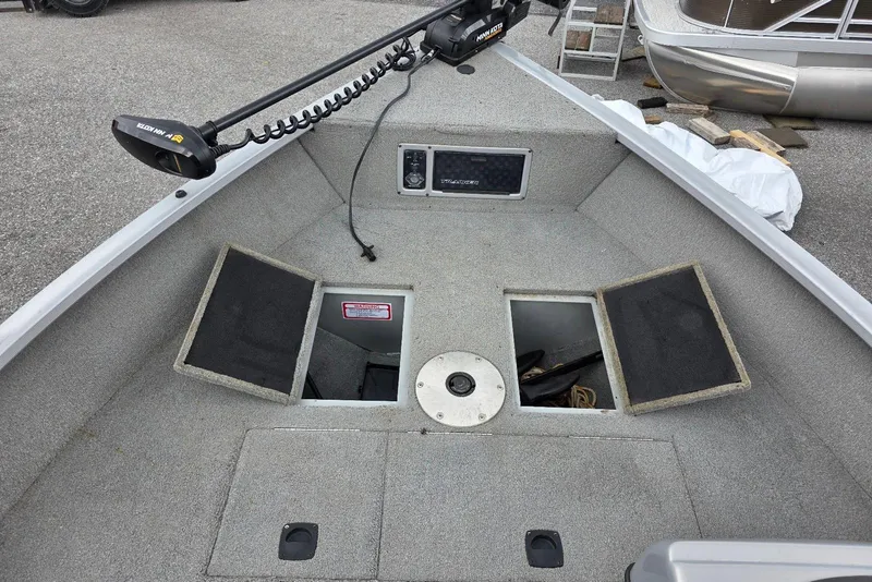 Slide: The Image of 2005 TRACKER BOATS Targa V16 Side Console interior with storage compartments and trolling motor. - 10