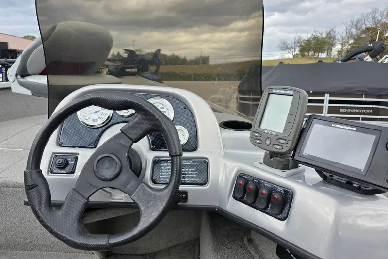 Slide: The Image of 2005 TRACKER BOATS Targa V16 console with steering wheel, gauges, and navigation equipment. - 14