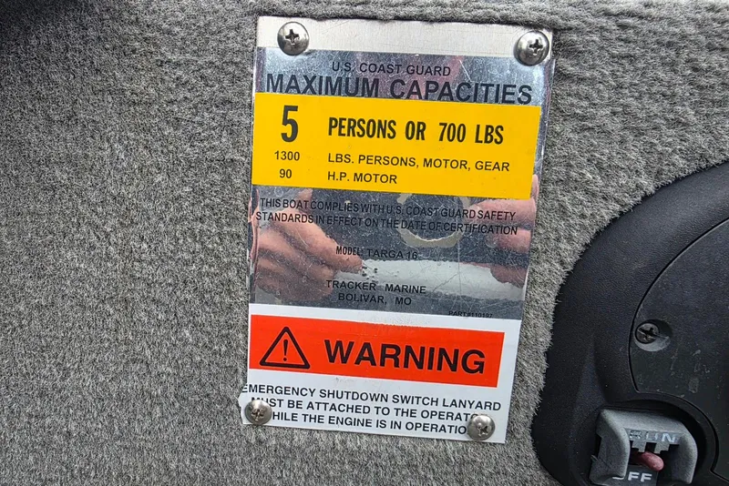 Slide: The Image of 2005 TRACKER BOATS Targa V16 capacity label, US Coast Guard compliance, warning notice. - 17