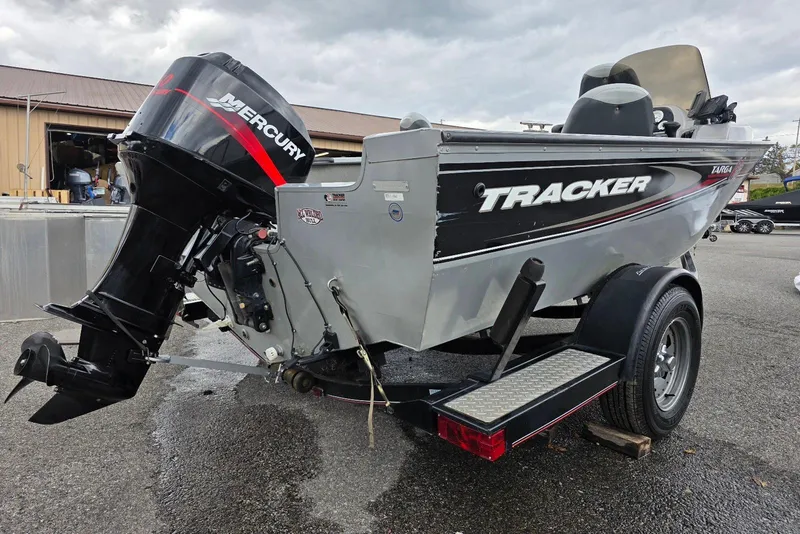 Slide: The Image of 2005 TRACKER BOATS Targa V16 Side Console with Mercury outboard motor on trailer. - 2