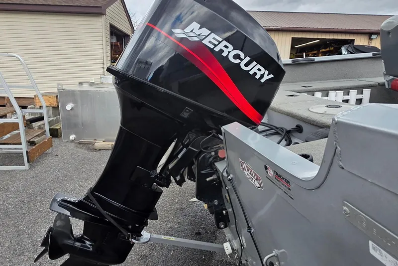 Slide: The Image of 2005 TRACKER BOATS Targa V16 with Mercury outboard motor in a storage area. - 3