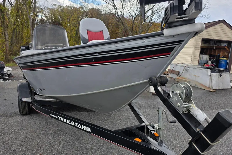 Slide: The Image of 2005 TRACKER BOATS Targa V16 Side Console on a TRAILSTAR trailer, parked outdoors. - 5
