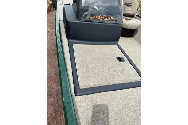 Slide: The Image of 2026 Tracker Bass Tracker Classic Limited boat interior with carpeted deck and seating. - 11