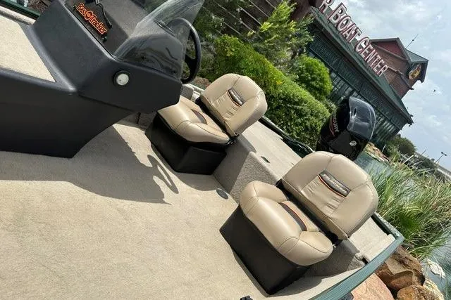 Slide: The Image of 2026 Tracker Bass Tracker Classic Limited boat interior with beige seats near a boat center. - 8