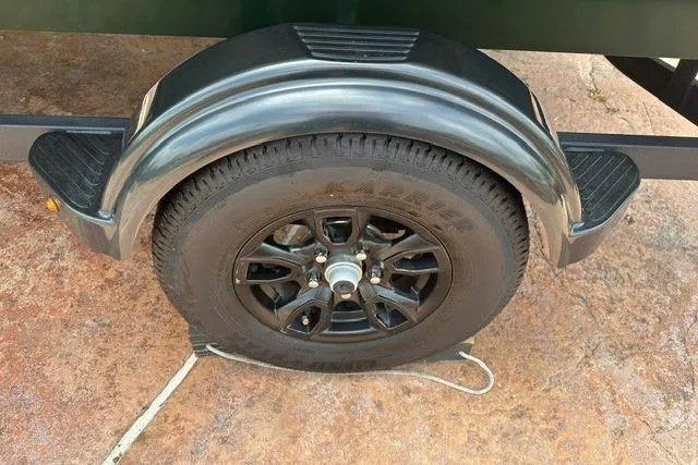 Slide: The Image of 2026 Tracker Bass Tracker Classic Limited trailer wheel on concrete surface. - 14