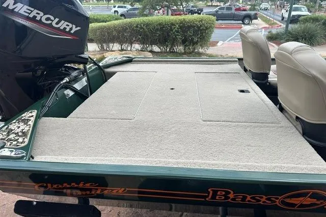 Slide: The Image of 2026 Tracker Bass Tracker Classic Limited boat with Mercury engine, featuring spacious deck and seating. - 7