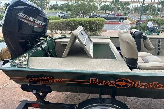 Slide: The Image of 2026 Tracker Bass Tracker Classic Limited boat with Mercury engine in parking lot. - 6