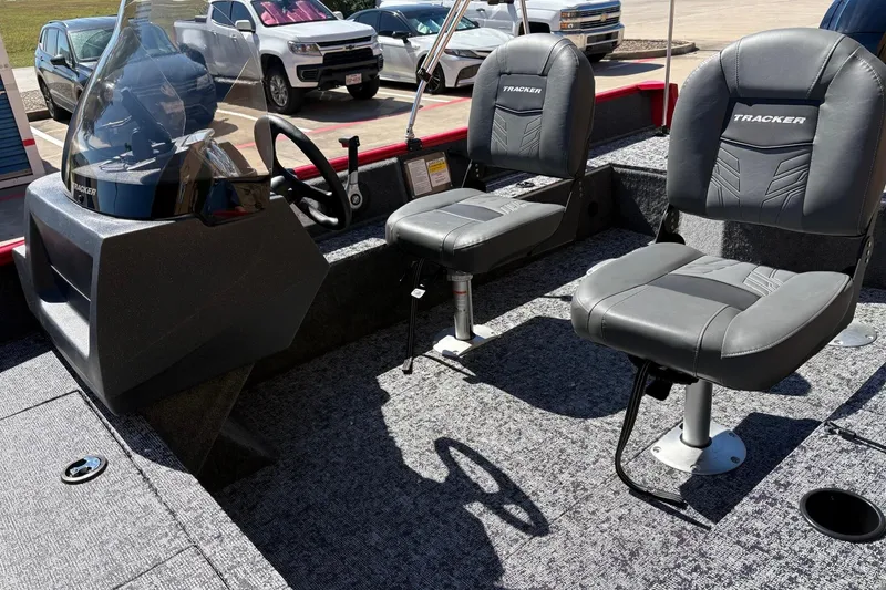 Slide: The Image of 2026 Tracker Pro Guide V-16 SC boat interior with steering console and two seats. - 47