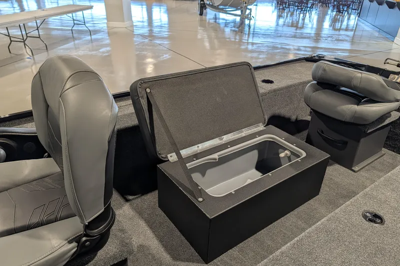 Slide: The Image of 2025 Tracker Panfish 17 boat interior with open storage compartment and seating. - 46