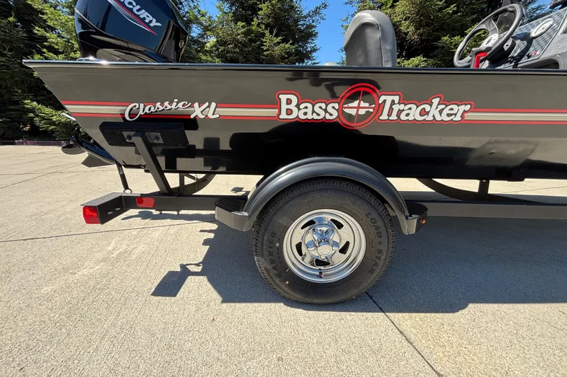 Slide: The Image of 2026 Tracker Bass Tracker Classic XL boat on trailer, featuring sleek black design. - 34